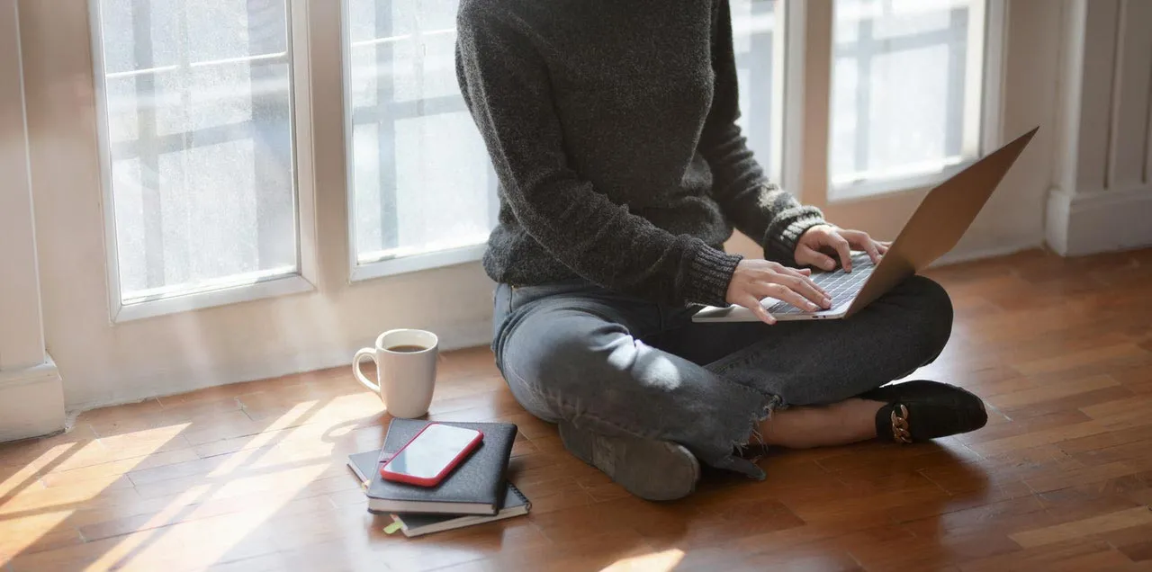 Young Woman Working from home because of COVID-19 (coronavirus)